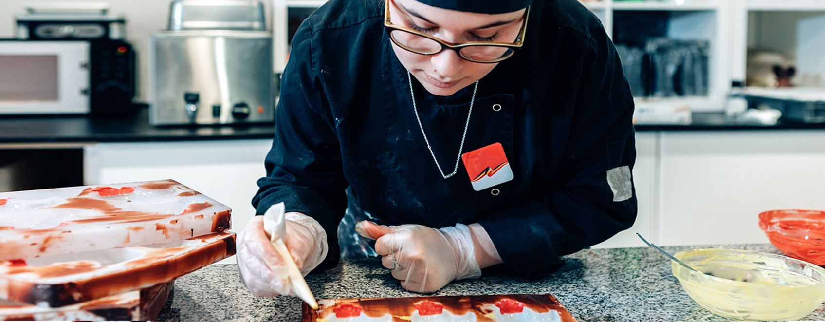 Candy maker puts finishing touches on product at candy store.